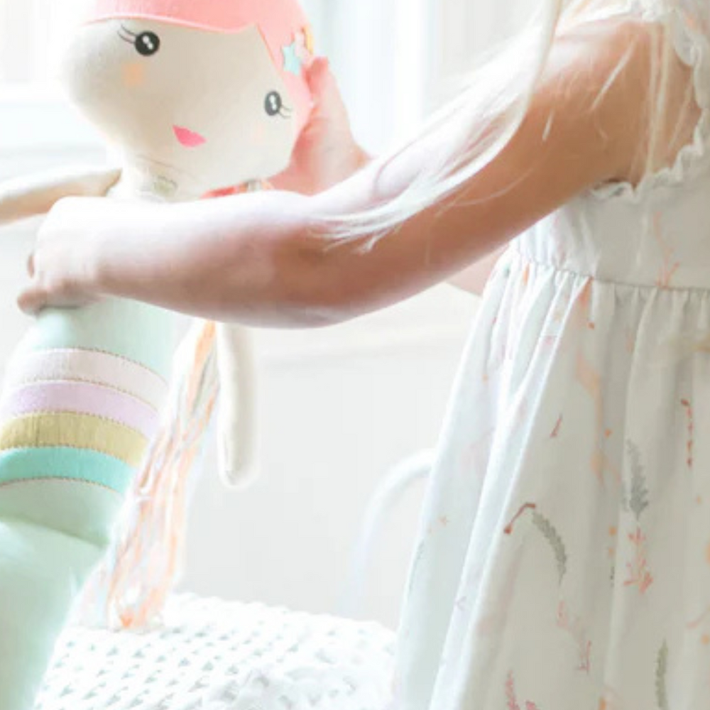 
                      
                        A delighted girl dancing with her Shine Mermaid Kindness Doll, enjoying the fun and positive energy this kindness ambassador brings to playtime.
                      
                    