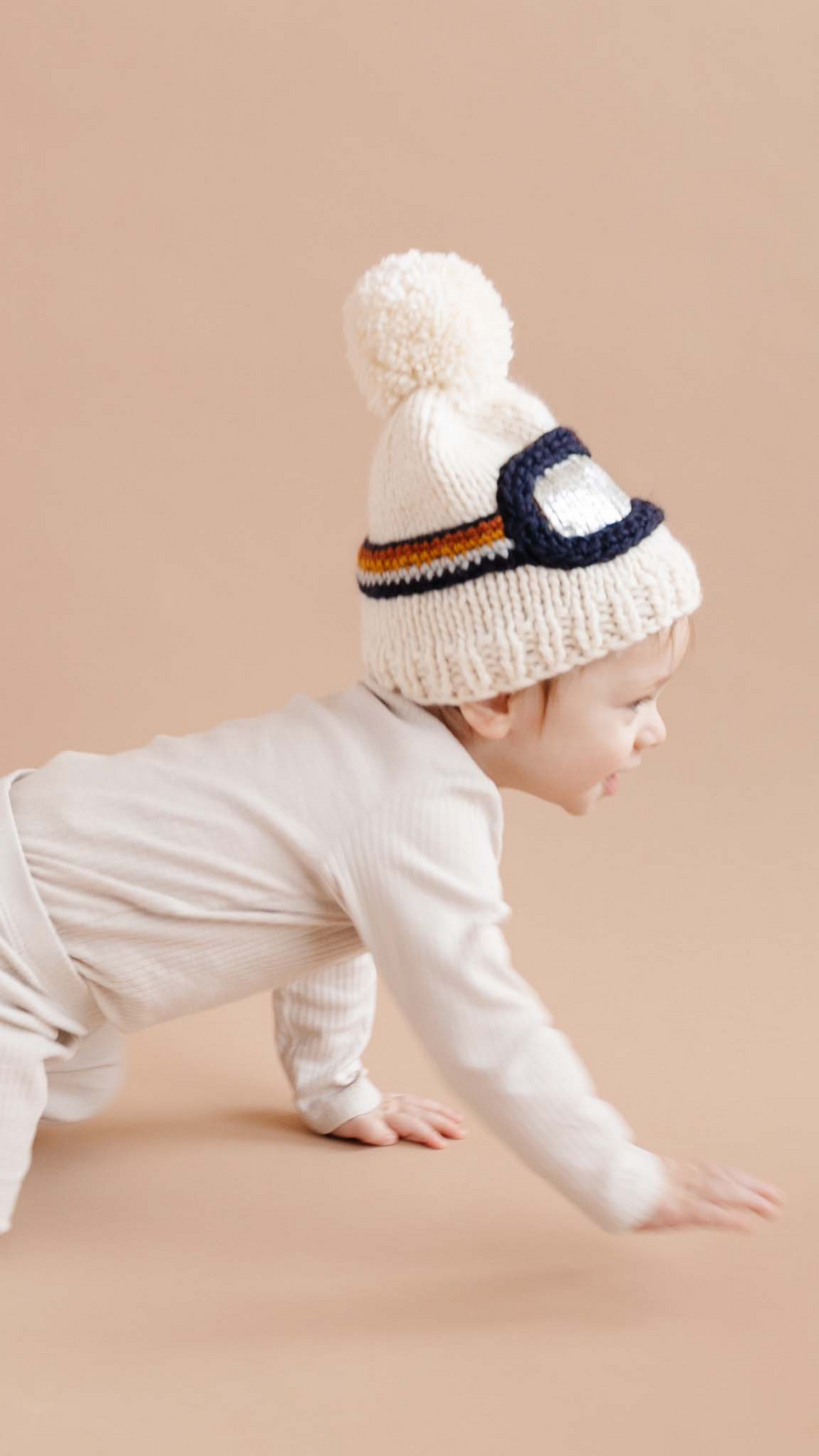 Side profile of child wearing the Ski Goggles Hat Winter Beanie, featuring silver metallic accents and a cozy knit design for warmth and style.