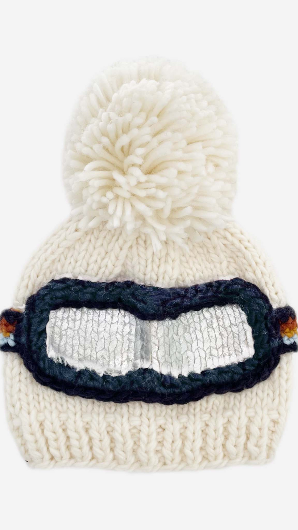 Front view of Ski Goggles Hat in cream with navy, cinnamon, mustard, and grey goggle band, topped with a playful pom-pom, perfect for winter adventures.