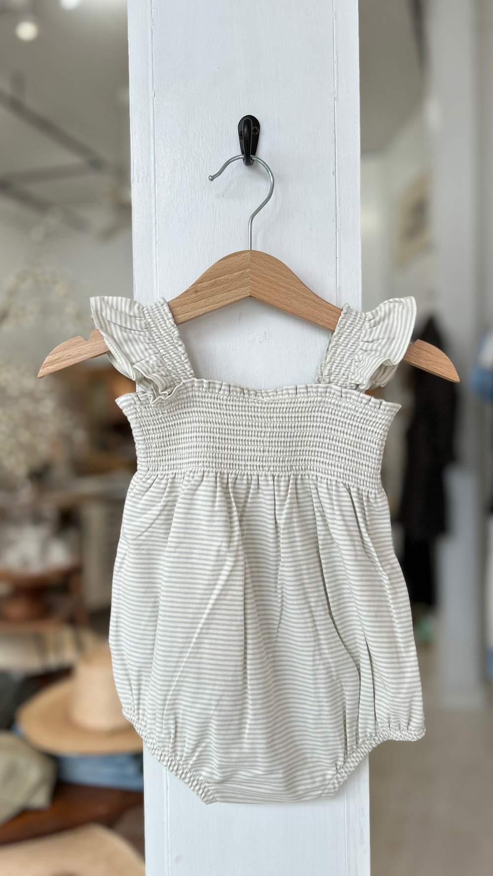 The Rylee + Cru Smocked Ruffle Sleeve Romper – Sky Stripe is a dreamy blend of comfort and charm, perfect for warm-weather adventures. 