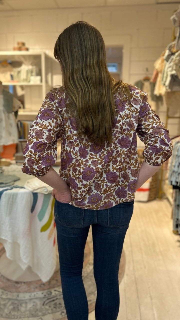 Back view of the Sophie Top in Lilac Orsay Floral by Marea – showcasing the relaxed fit, ruffle detailing, and elegant floral print, perfect for spring and summer.