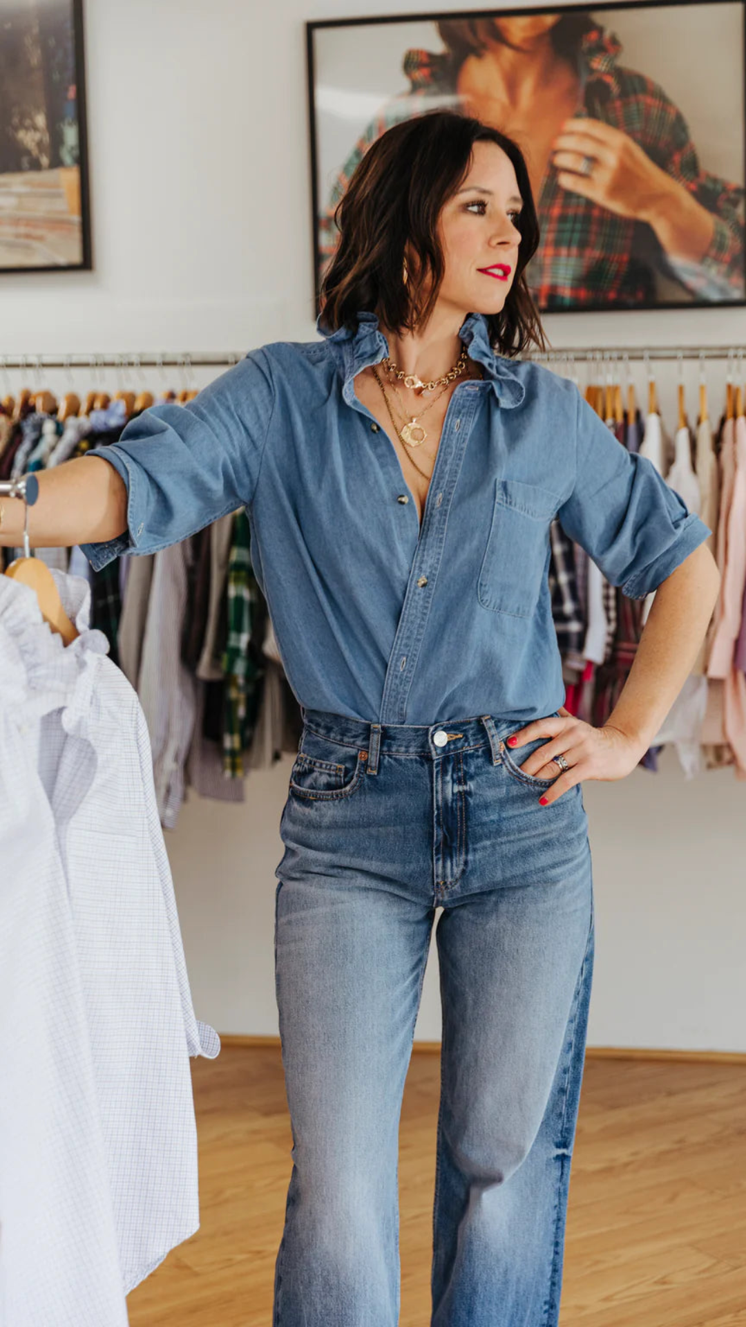 Denim ruffle collar blouse styled with sleeves rolled up and tucked in for versatile look