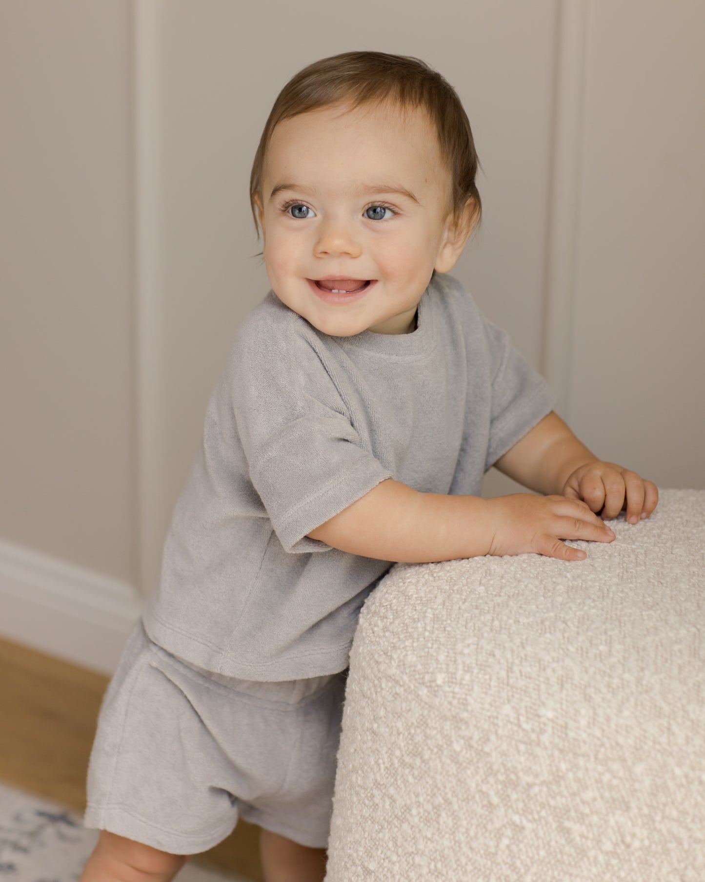Adorable toddler boy wearing the Quincy Mae Organic Cort Terry Matching Top & Shorts set. The soft and cozy organic cotton fabric ensures comfort all day long, while the stylish terry design adds a modern touch. Perfect for warm weather, this set combines playful style with sustainability, making it a great choice for active little ones. The matching top and shorts offer a coordinated look, ideal for any occasion.