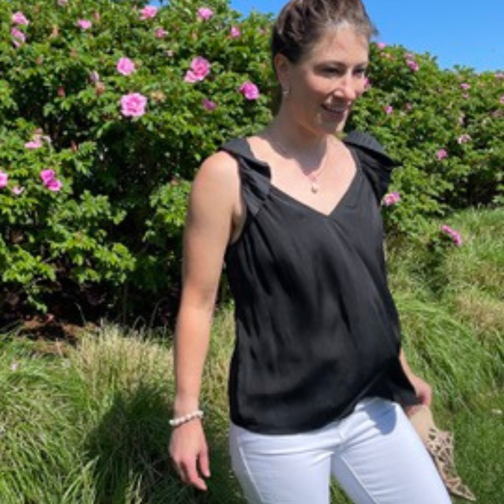 Versatile Black Pleated Ruffle Top with a sweetheart neckline, offering a sustainable design with 50% recycled polyester for eco-friendly fashion