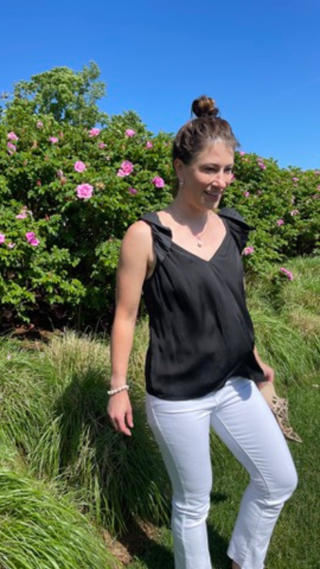 Versatile Black Pleated Ruffle Top with a sweetheart neckline, offering a sustainable design with 50% recycled polyester for eco-friendly fashion