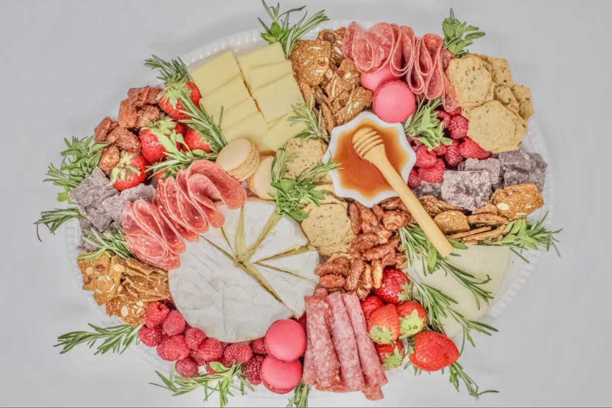 Event feature image for our Valentine's Day Charcuterie Workshop in Essex, CT, hosted by Kayty Helgerson. This inviting setup showcases beautifully arranged charcuterie boards, perfect for couples and friends to learn the art of creating stunning and delicious spreads together.
