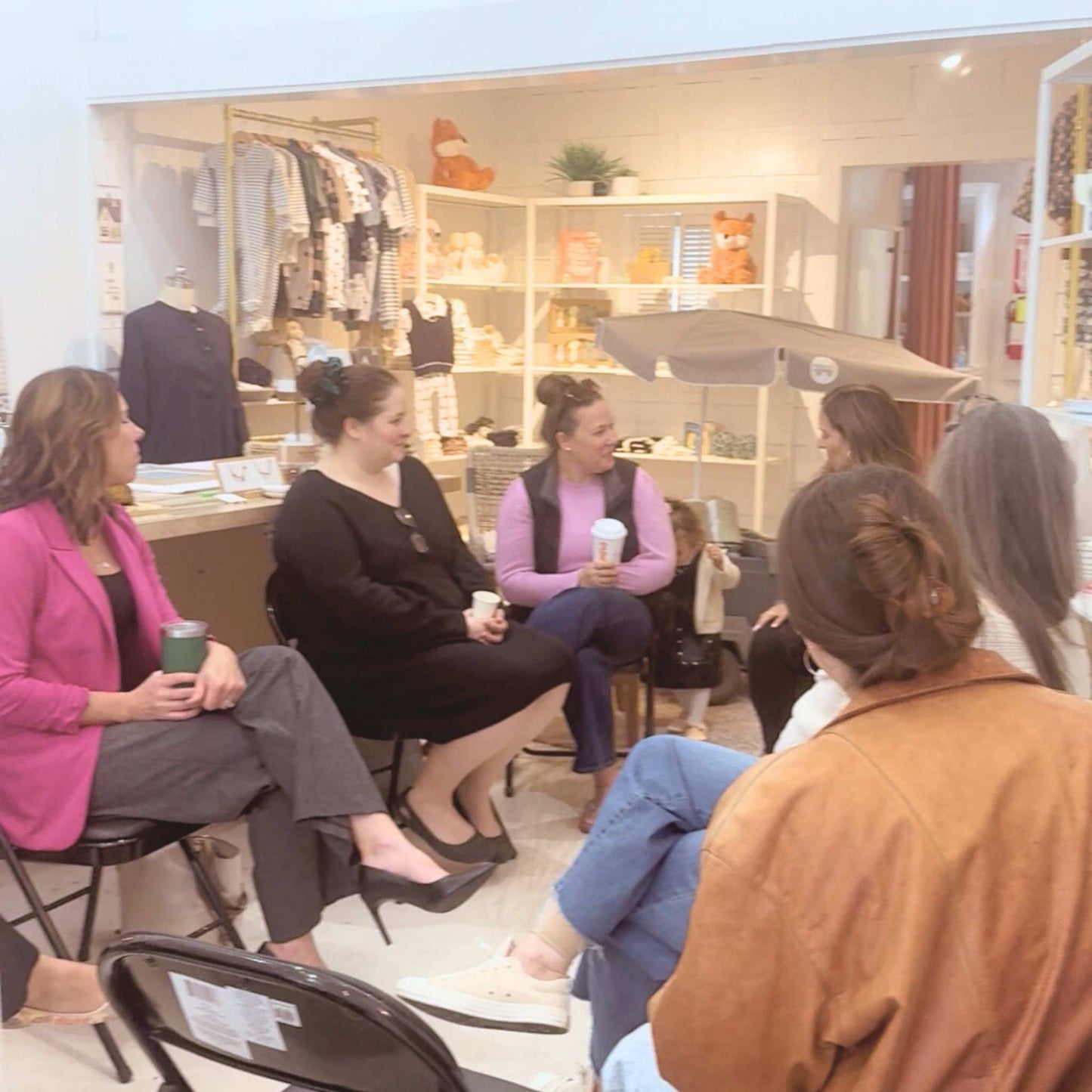 Group of women at Grace & Haven, engaged in conversation at our bi-weekly Women in Business Networking Coffee.