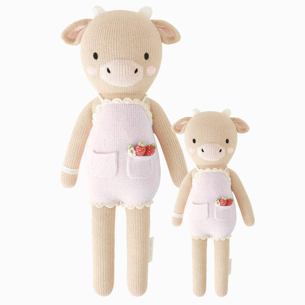 Front flatlay of Ava the Cow lavender plush dolls in both 13-inch and 20-inch sizes, hand-knit with 100% cotton yarn by Cuddle + Kind