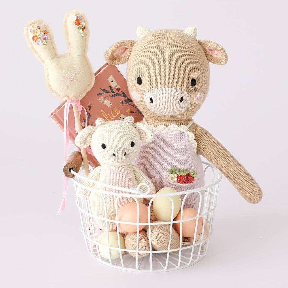 
                      
                        Ava the Cow lavender doll styled in a gift basket with baby essentials, ideal for baby shower or newborn welcome gift
                      
                    