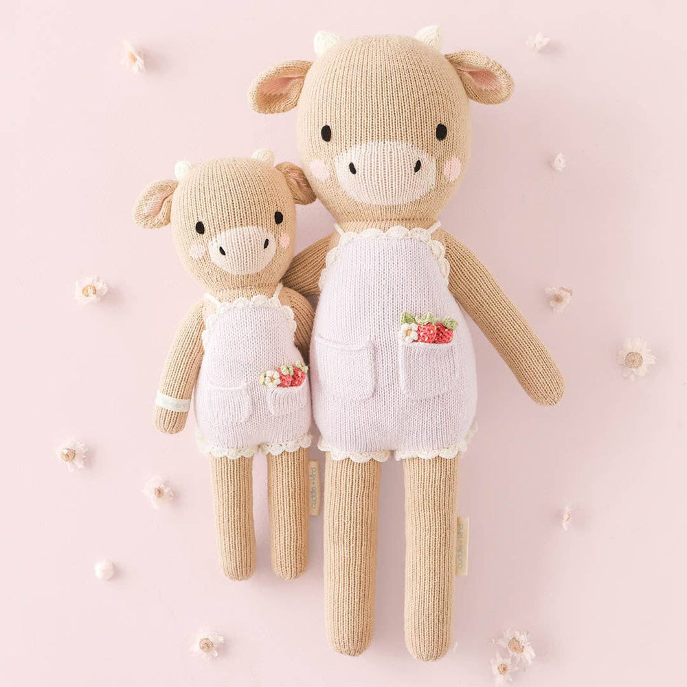 
                      
                        Styled flatlay of Ava the Cow dolls in both sizes with neutral props, showcasing her timeless design and heirloom quality
                      
                    