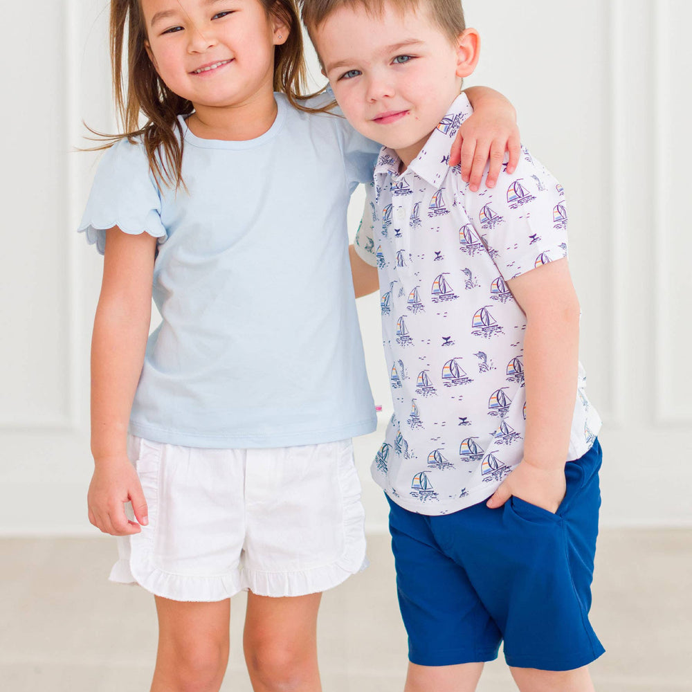 Baby girl wearing light blue puff sleeve bodysuit and coordinating shorts, front view showing sweet and classic style