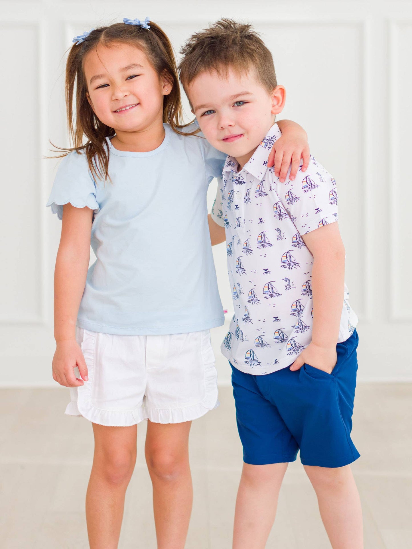 Baby girl wearing light blue puff sleeve bodysuit and coordinating shorts, front view showing sweet and classic style