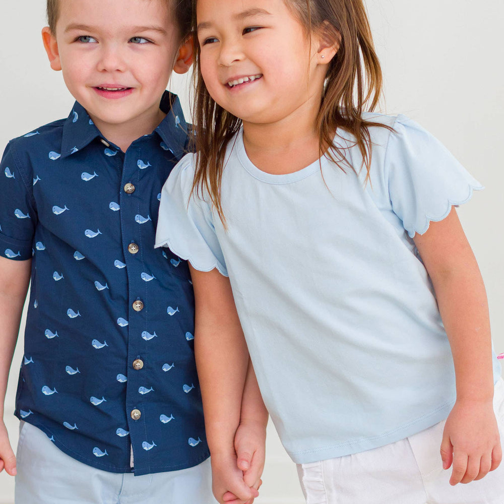 
                      
                        Side view of baby girl in blue shirt and shorts, perfect spring outfit for play and photos
                      
                    