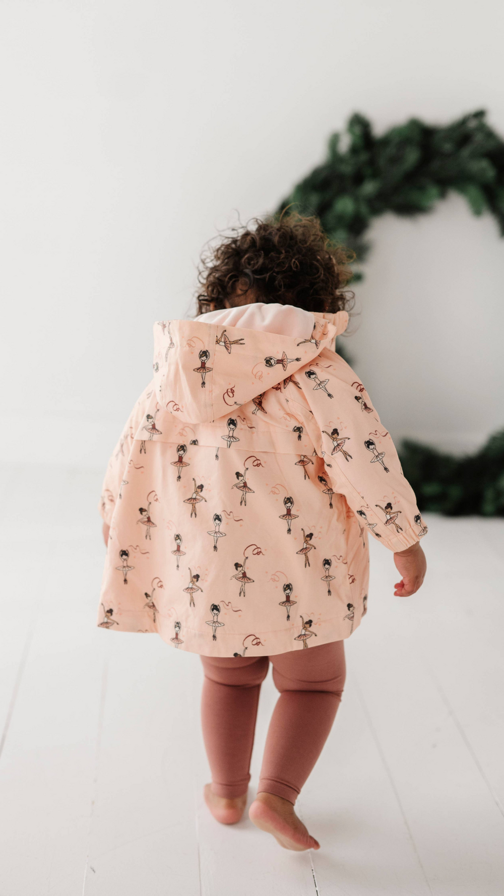 Back view of toddler in Ballerina cotton jacket, showing unique print from Fall Collection. Warm and comfortable jacket for fall and winter.