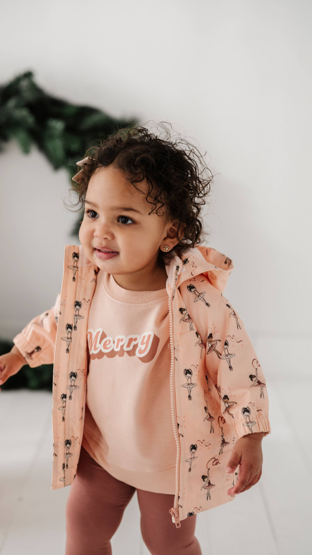 Front view of toddler in Ballerina cotton jacket from Fall Collection, featuring functional pockets and warm fleece lining for cold weather.