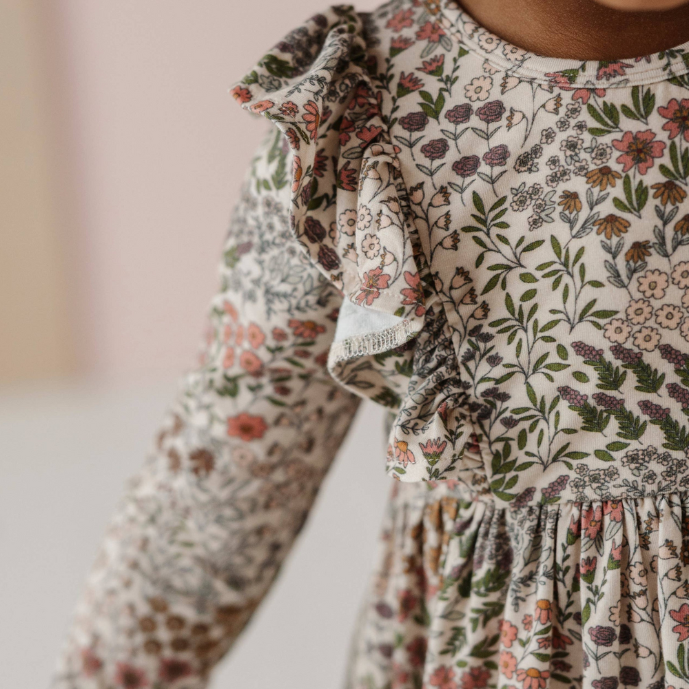 Close-up of ruffle detail on Baby & Toddler Ruffle Dress in Winter Floral, highlighting the soft fabric and charming design for a playful touch.