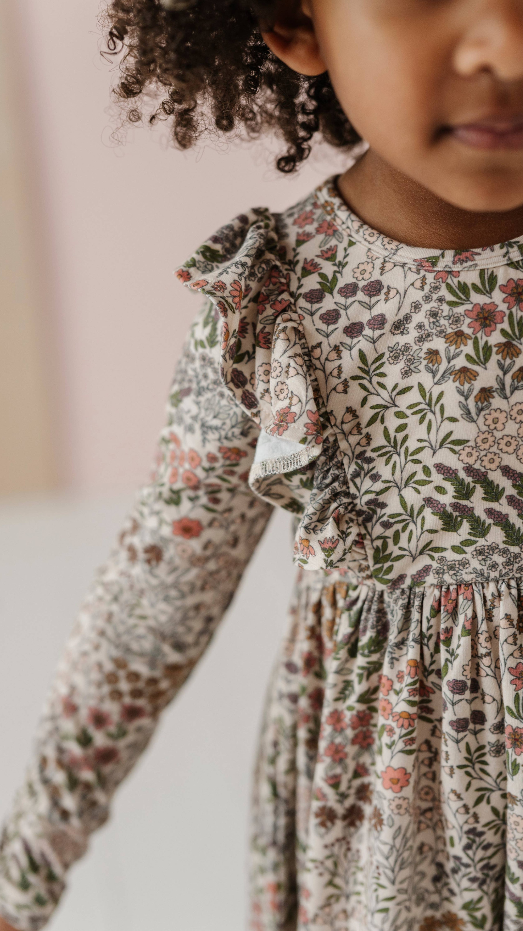 Close-up of ruffle detail on Baby & Toddler Ruffle Dress in Winter Floral, highlighting the soft fabric and charming design for a playful touch.