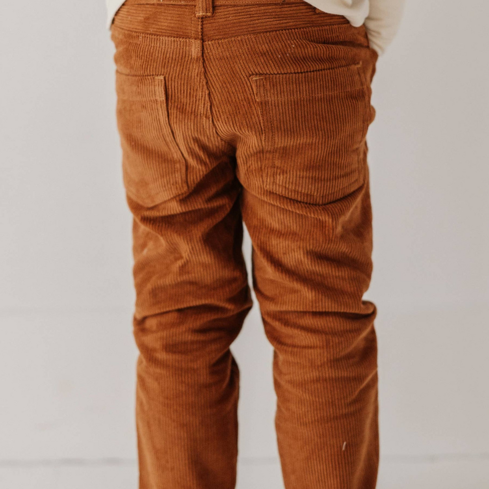 
                      
                        Back view of boy in Corduroy Pants, showcasing the comfortable fit and quality craftsmanship for active play.
                      
                    