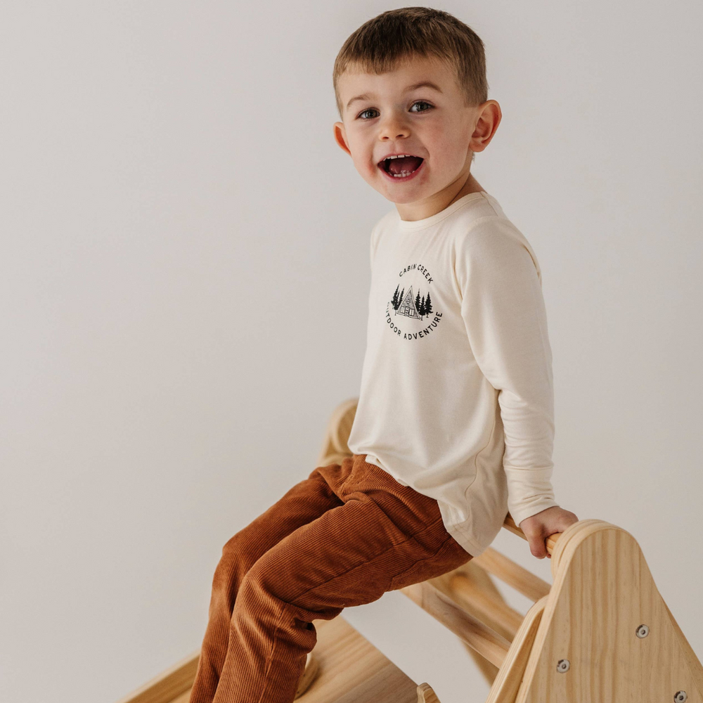 
                      
                        Little boy playing and having fun in Corduroy Pants, capturing the playful spirit and comfort of these stylish trousers.
                      
                    