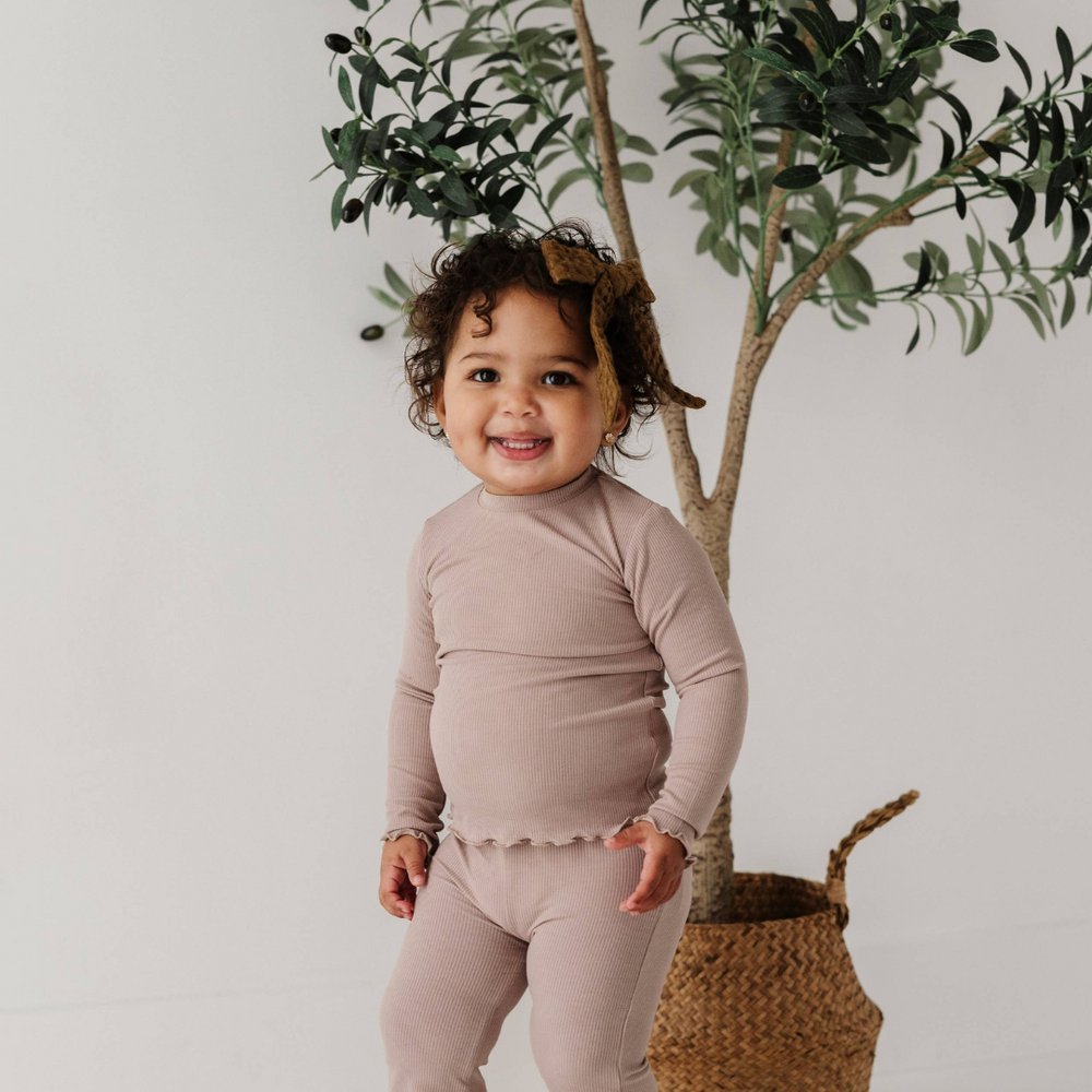 
                      
                        Toddler in lilac lettuce hem tee paired with bamboo flare pants, a stylish and comfortable outfit for fall layering
                      
                    