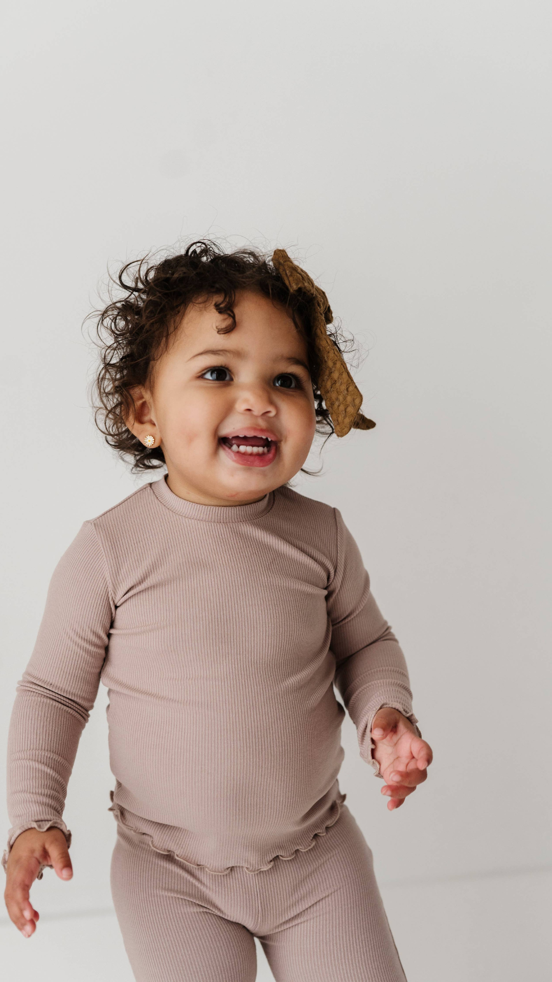 Toddler wearing lilac bamboo long sleeve tee with lettuce hem in studio, showcasing soft fabric and playful design for everyday wear.