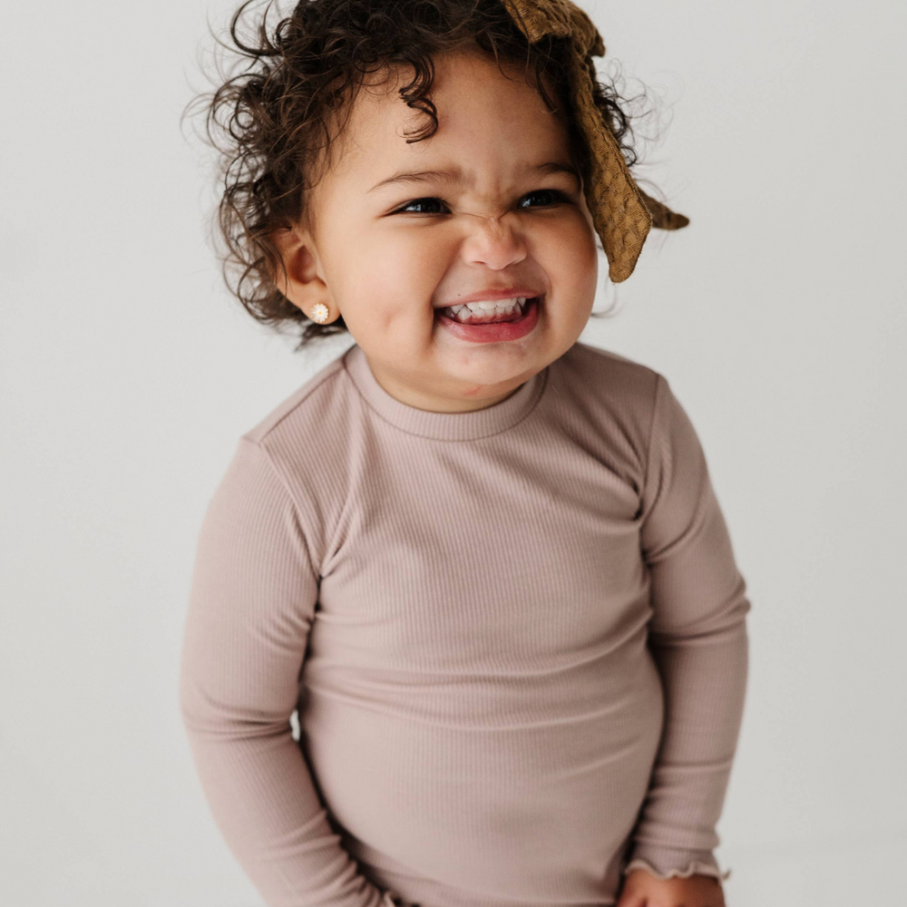 Close-up of soft, stretchy bamboo ribbed long sleeve tee in lilac with lettuce hem detail, perfect for toddlers’ comfort and mobility