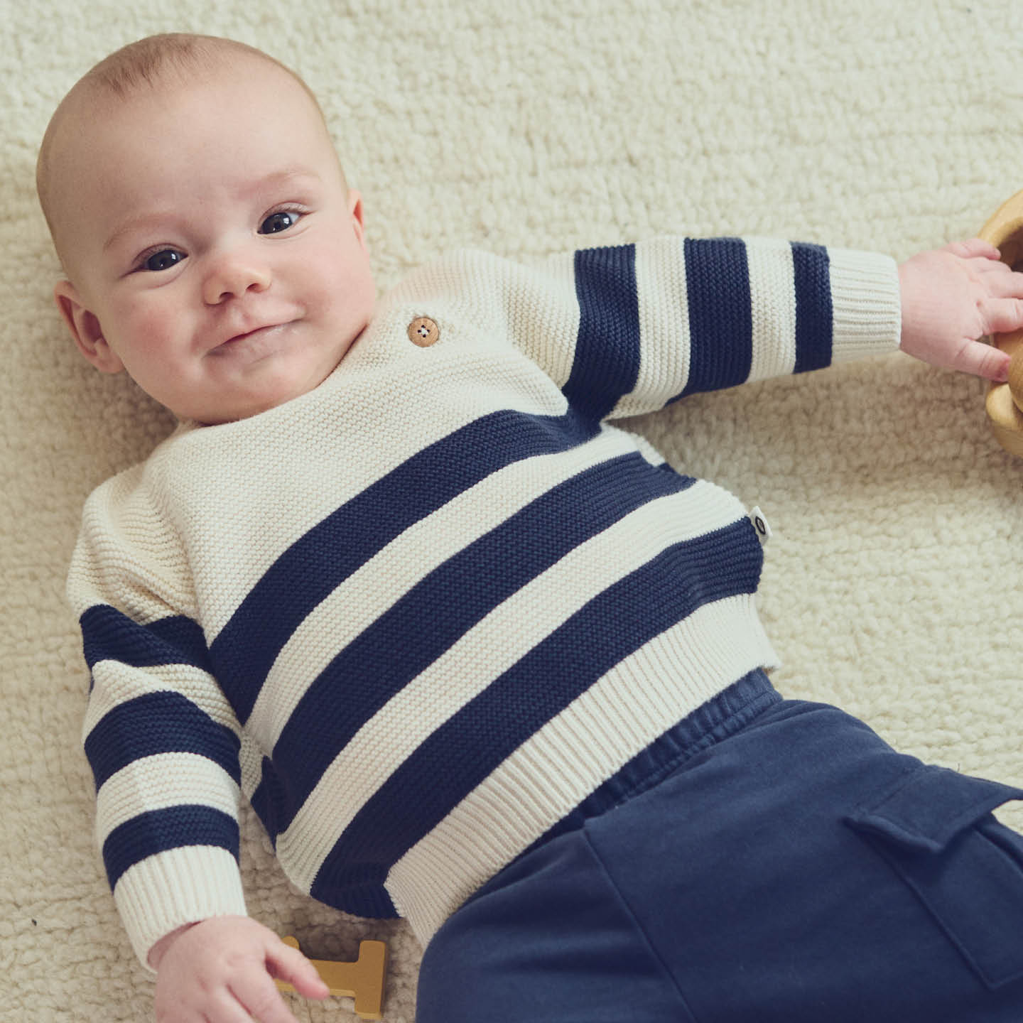 Baby wearing the Musli Knit Stripe Sweater in Night Blue, paired with coordinating navy joggers for a cozy fall outfit