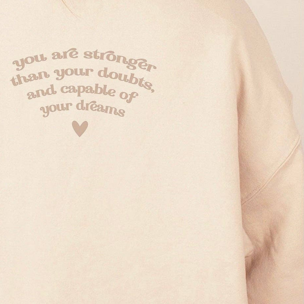 Back view of the neutral sand-colored crewneck sweatshirt showcasing the simple, clean design without additional graphics.