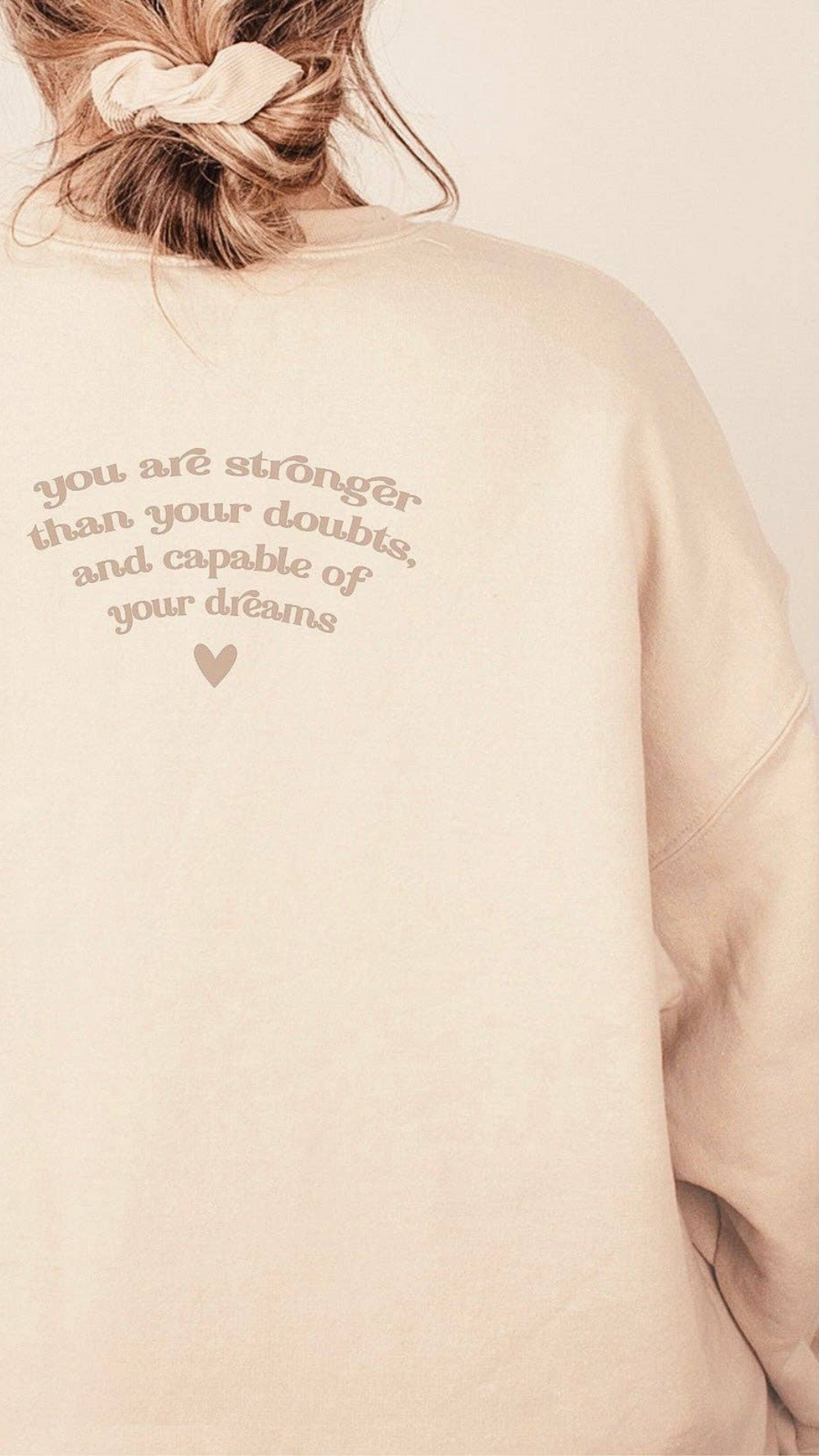 Back view of the neutral sand-colored crewneck sweatshirt showcasing the simple, clean design without additional graphics.