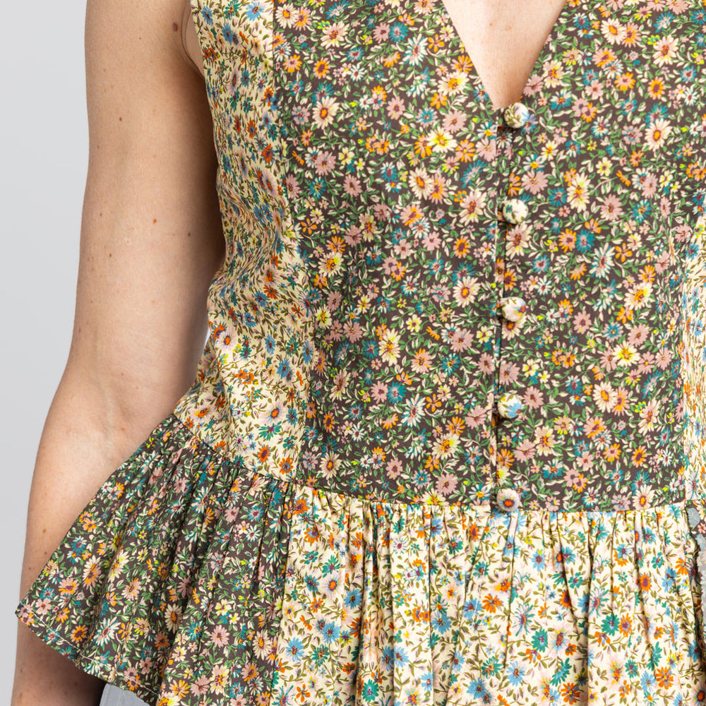 
                      
                        Close Up front view of the Beck Peplum Top with peplum detail in floral pattern.
                      
                    