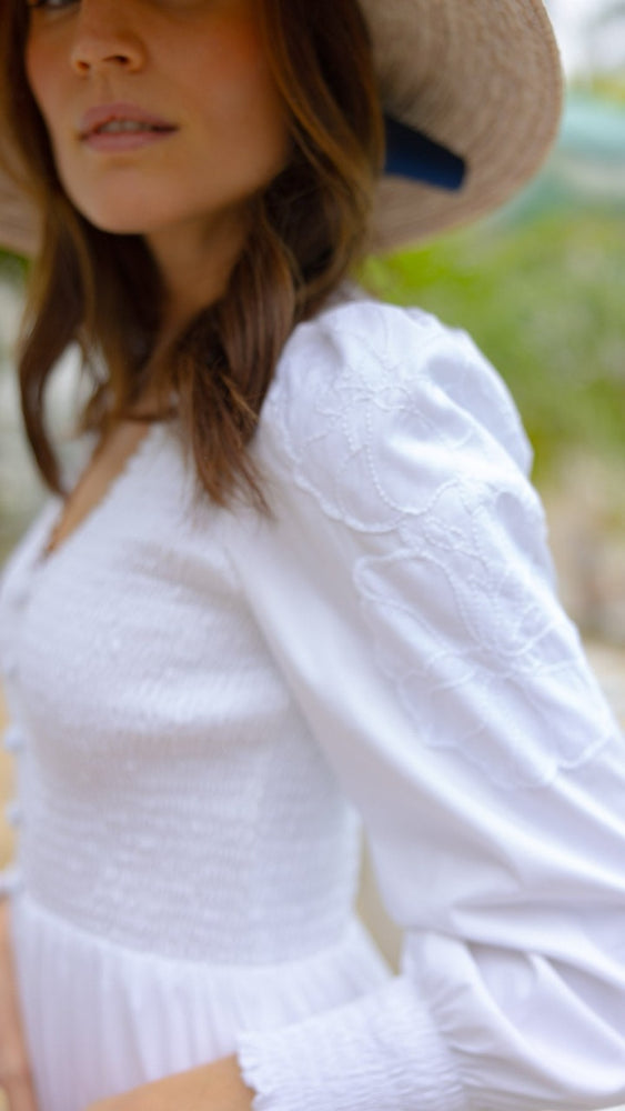 
                      
                        Close-up of floral appliqué on puff sleeve of the Blanche Dress
                      
                    