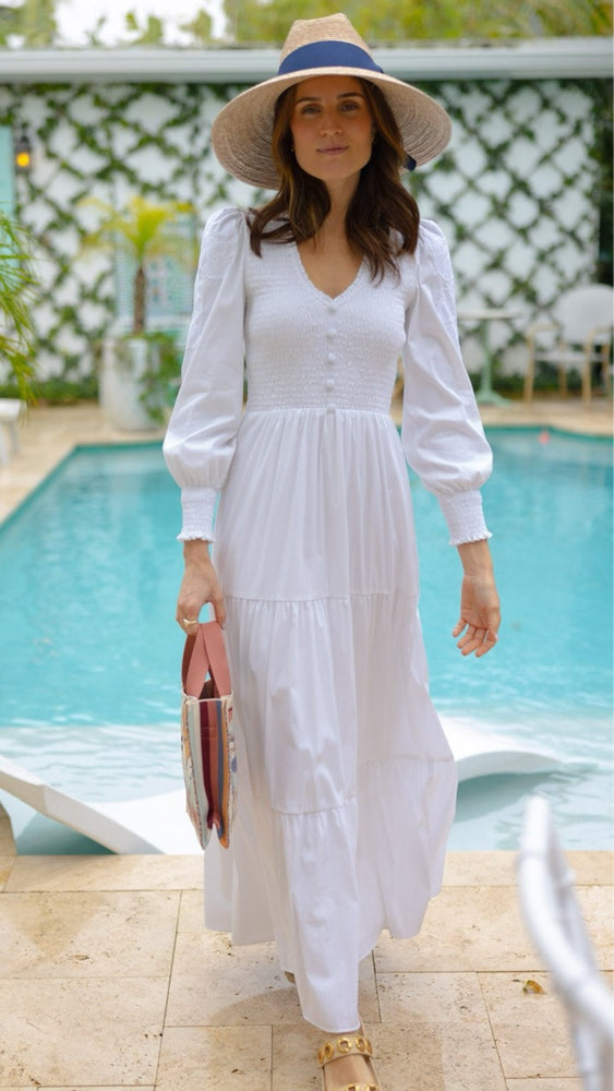 
                      
                        Woman in the Blanche Dress standing poolside in the sun
                      
                    