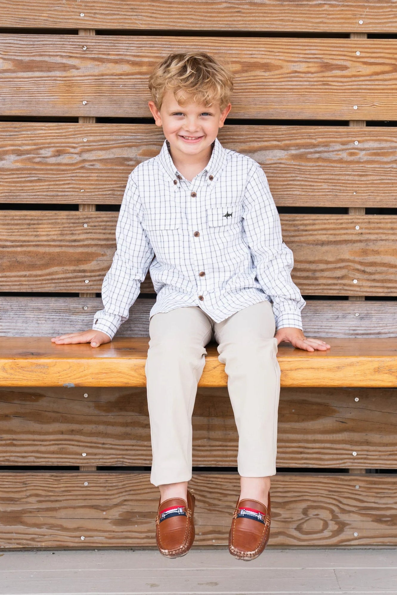 Young boy wearing Boys Flagler Fishing Shirt with Par Performance Pants and loafers, showcasing playful, stylish, and comfortable outfit.