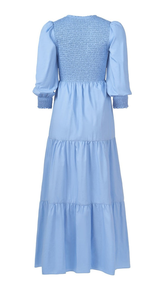 
                      
                        Back view flat lay of chambray Bridgette Dress, highlighting smocked cuff and soft flowing silhouette.
                      
                    