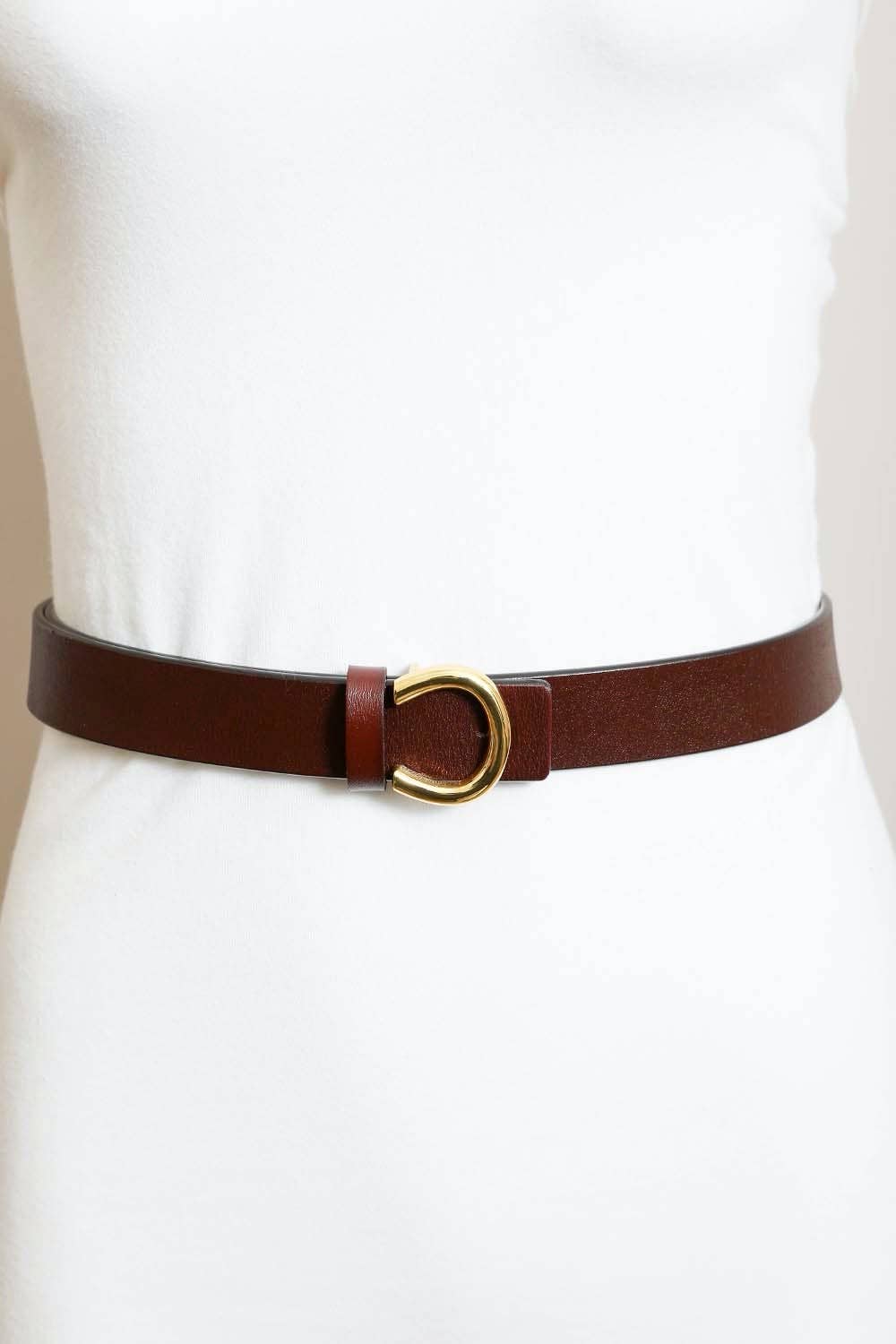 Brown leather belt with a gold buckle on a white dress form. The perfect fall accessory available at Grace & Haven in Essex, CT