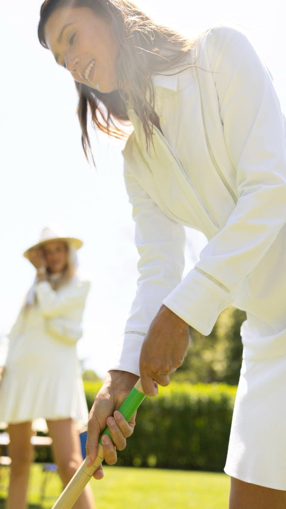 
                      
                        Model in the Callaway Dress playing croquet, demonstrating its breathable, UPF 50+ protection for sunny outdoor leisure.
                      
                    
