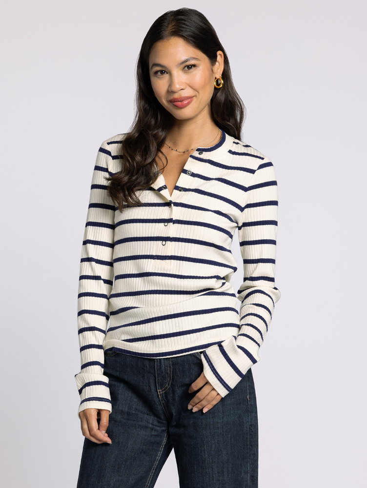 Model wearing the Carina Ivory and Navy Ribbed Henley, front view highlighting contrast neckline and button placket.