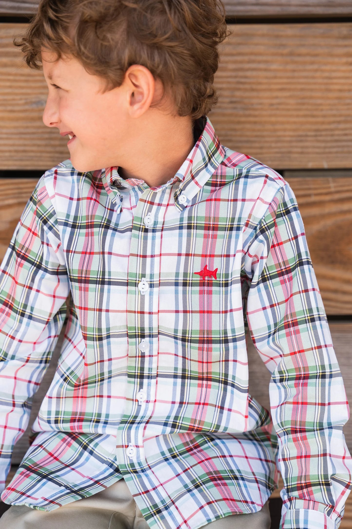 Young boy wearing Carter Oxford Shirt in creme plaid, showcasing versatile style and comfortable fit for everyday wear.