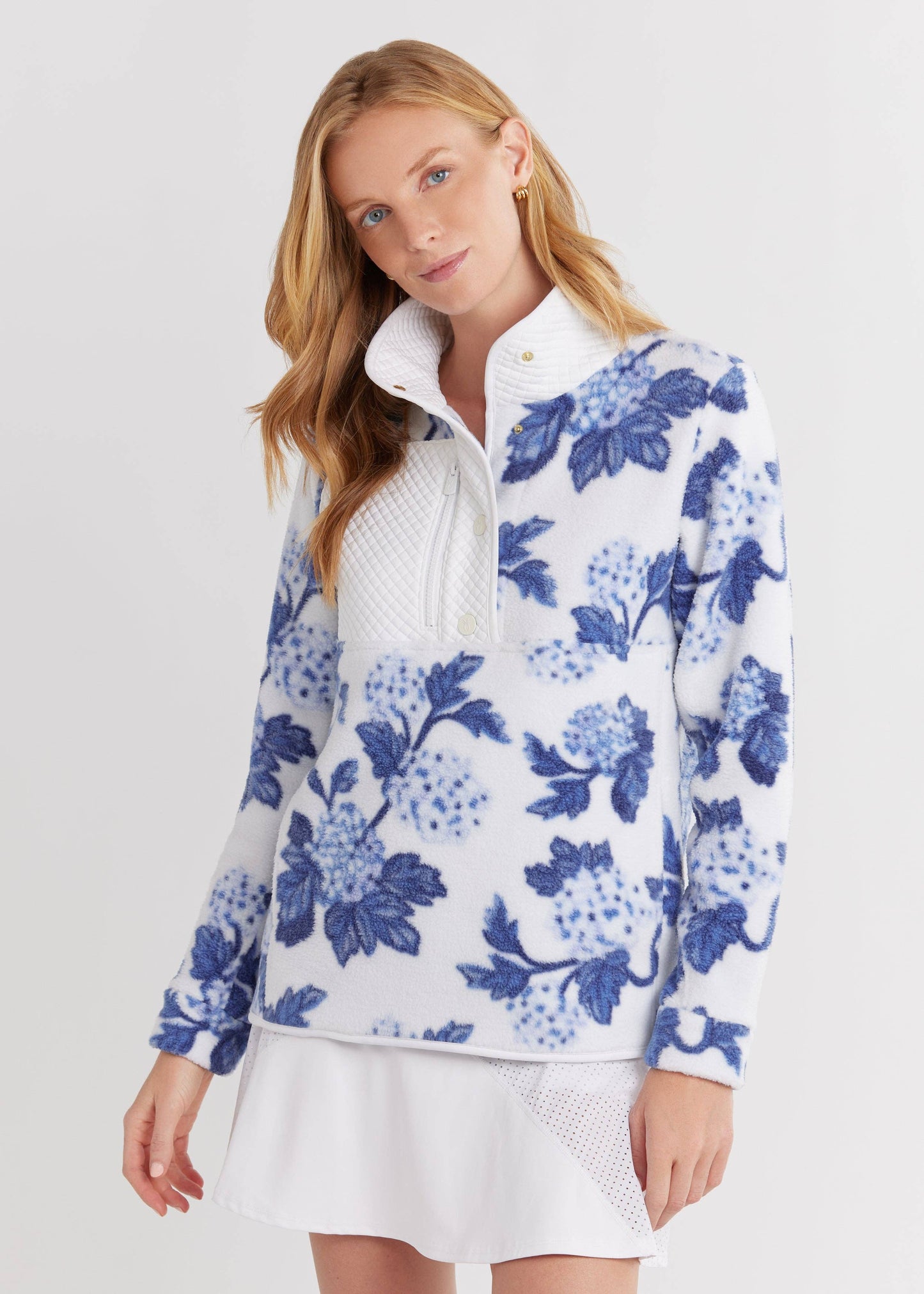 Model wearing Cherry Lawn Sherpa Fleece Pullover in hydrangea floral print, relaxed fit and chest zip pocket visible