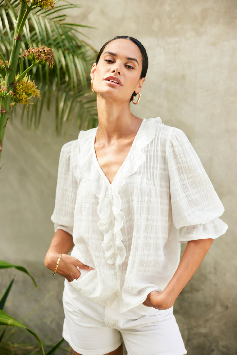 Model wearing the Chloe Shirt in textured plaid styled with shorts for a relaxed, feminine look.