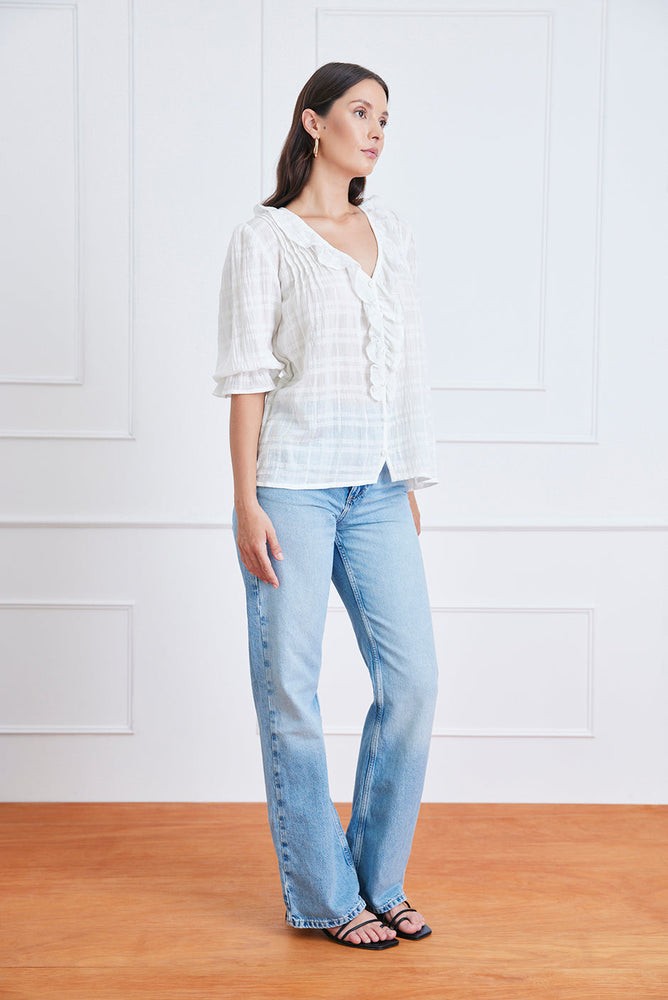 
                      
                        Right side studio view of the Chloe Shirt, styled with jeans to showcase the elegant sleeve drape and textured plaid fabric.
                      
                    