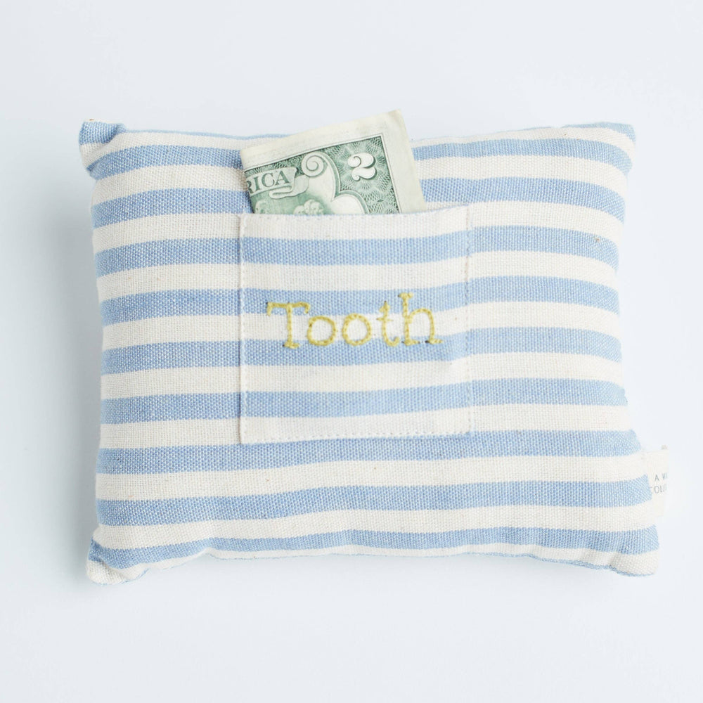 Close-up view showing the striped handwoven cotton fabric and small embroidered pocket of the tooth fairy pillow