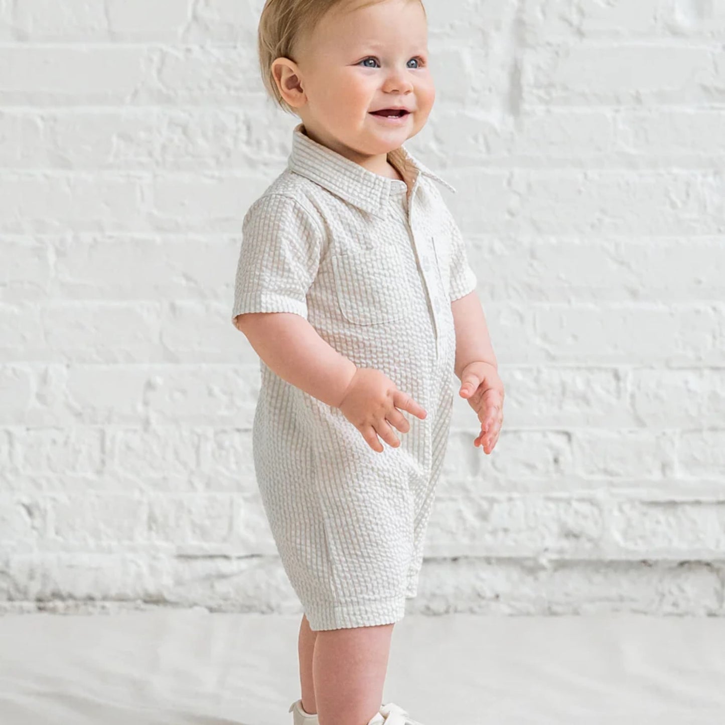 Side view of Colored Organics Mato Seersucker Collared Romper Dune Stripe showing side silhouette