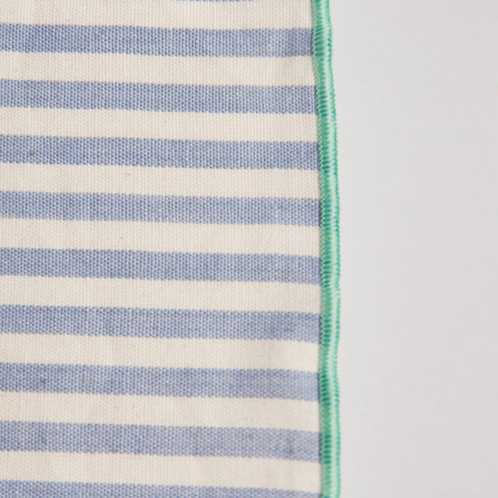 
                      
                        Close-up of the handwoven dinner napkin showing colorful side stitching detail along the edge, highlighting artisan craftsmanship and texture
                      
                    