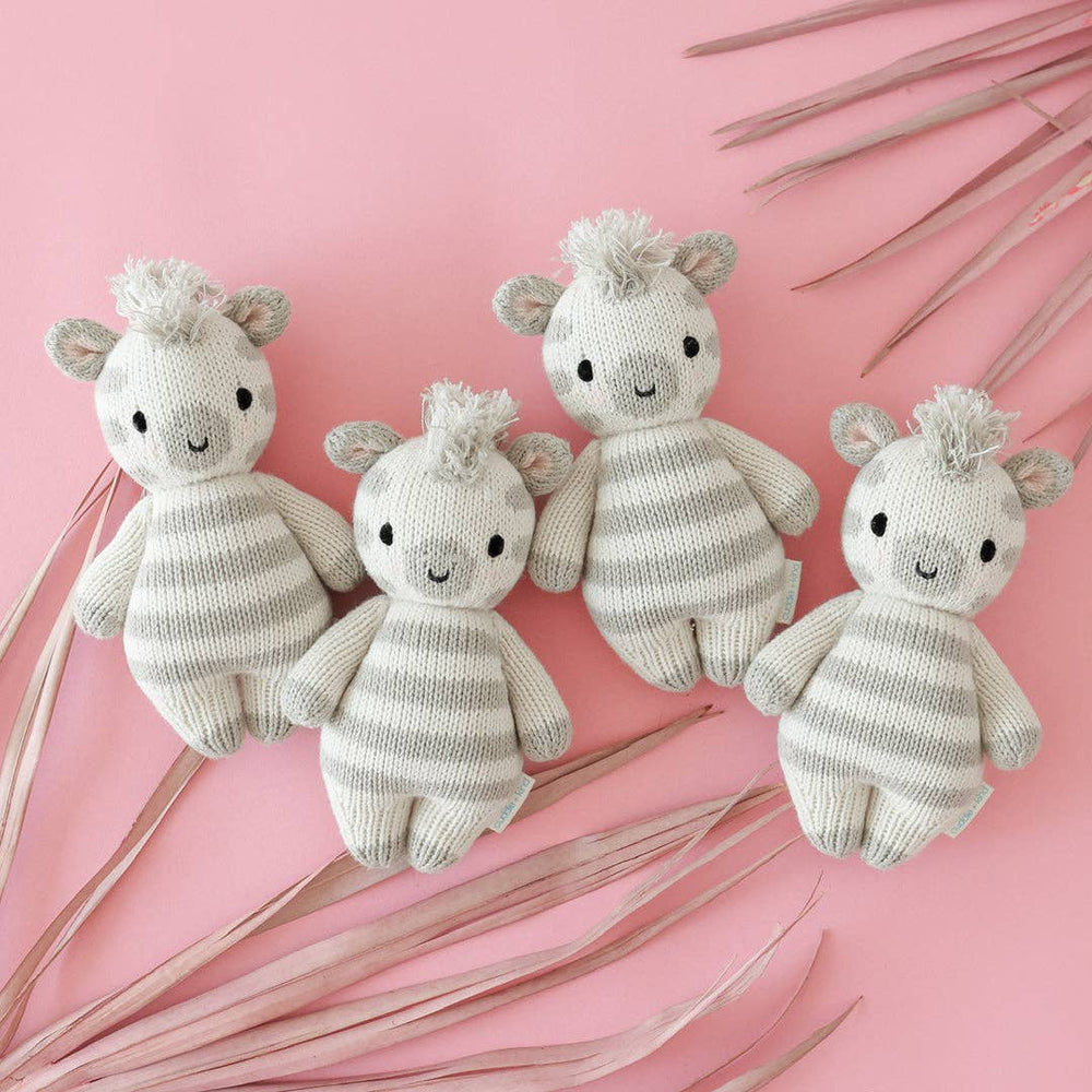 
                      
                        Set of four Cuddle + Kind Baby Zebra dolls displayed side by side on soft white background – fair trade, hand-knit baby toys
                      
                    