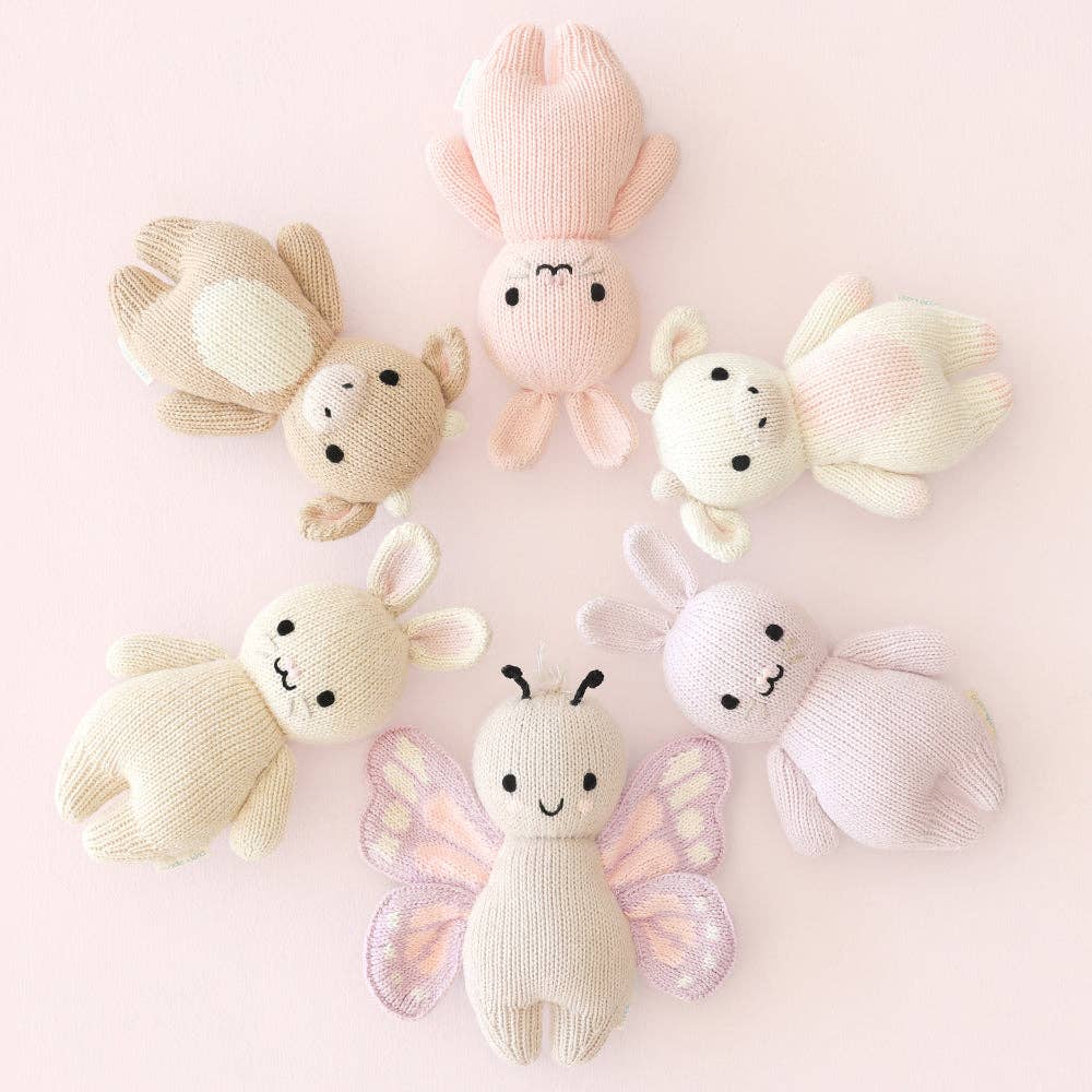 
                      
                        Cuddle + Kind Baby Butterfly surrounded by five other baby animals in a circle, styled in soft tones for playful display
                      
                    