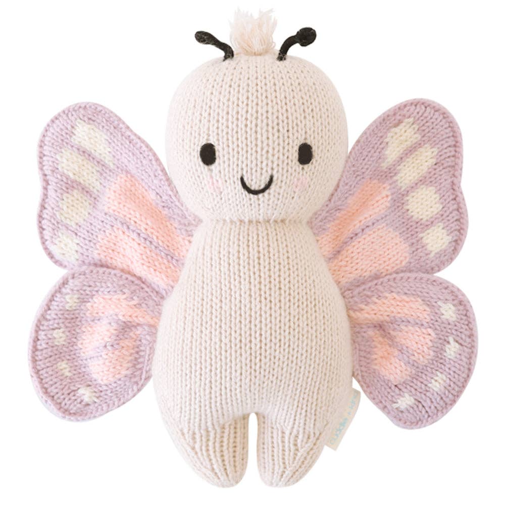 Front view of Cuddle + Kind Baby Butterfly doll laid flat, showcasing hand-knit details and butterfly wings