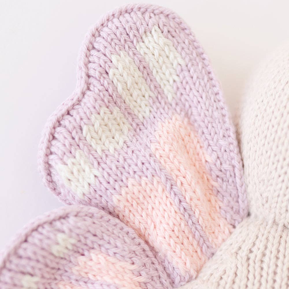 
                      
                        Close-up of Cuddle + Kind Baby Butterfly’s wing showing intricate hand-knit cotton detail and pastel stitching
                      
                    
