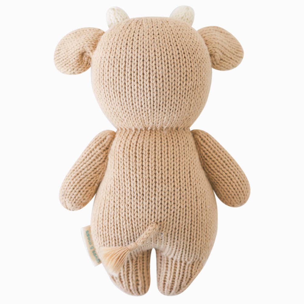 Back flatlay of Cuddle + Kind Baby Cow (Jersey) showing soft hand-knit detailing and tail, made from 100% cotton yarn