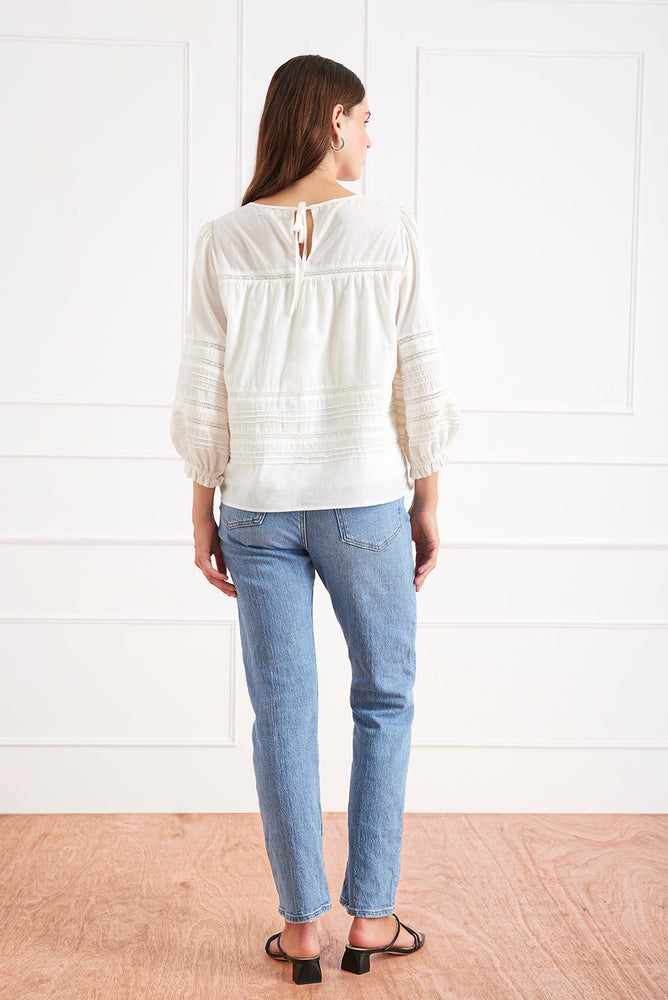 
                      
                        Back view of the Dawn Blouse, showcasing the soft drape of the cotton voile and full sleeve design.
                      
                    